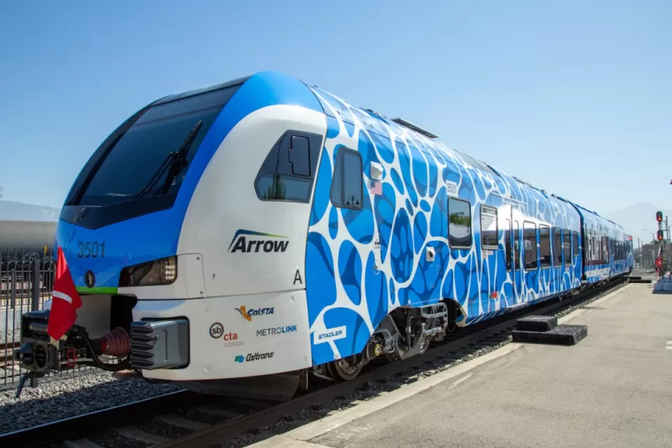 Blue and white Zero-Emission Multiple Unit (ZEMU) hydrogen-powered train in San Bernardino, California.